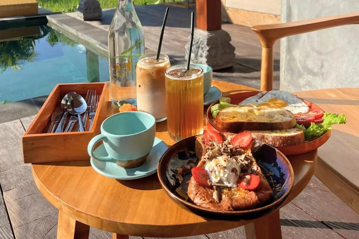 Asiki A cup of coffee and a beautiful breakfast plate on a table
